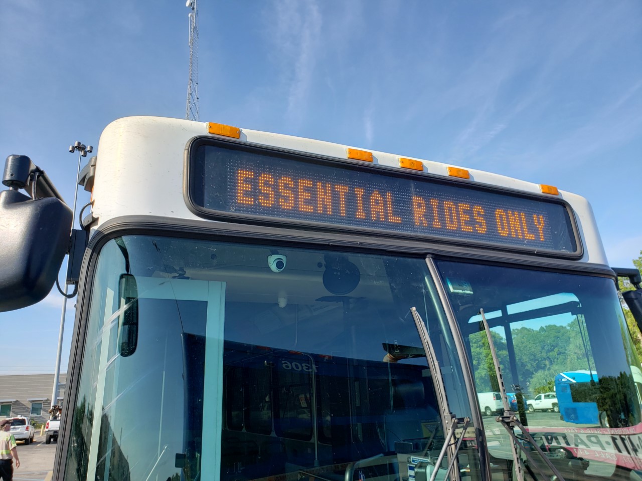Parked bus has on their front LED sign, Essential Rides Only